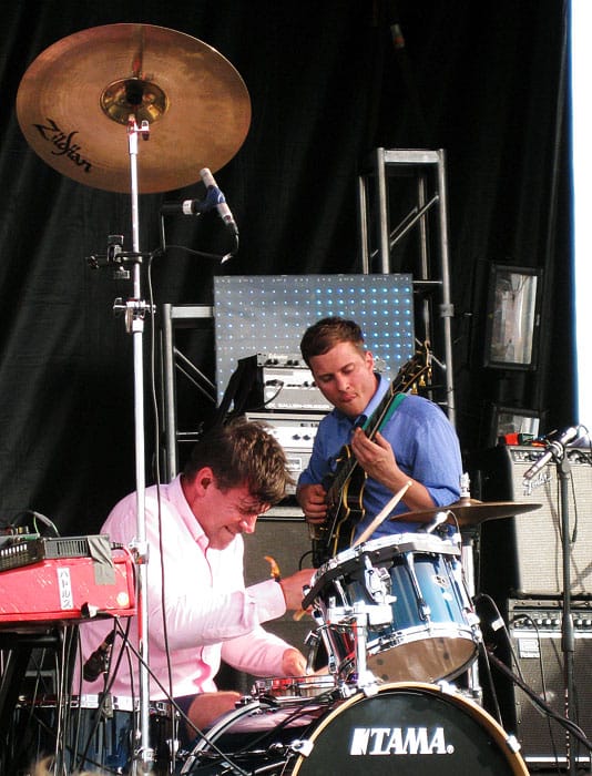 Battles' drummer John Stawnier playing his kit with an extremely high cymbal