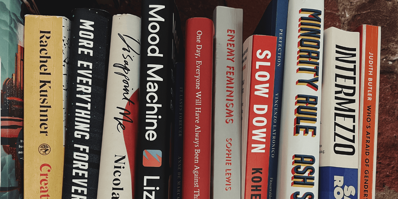 A pile of books. Except the image has been rotated sideways and cropped so it looks like a row of books. But it's not. It's a pile. Of books.